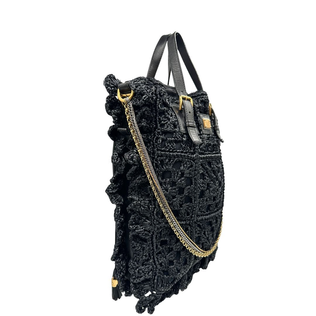 lato  Borsa Dolce & Gabbana in rafia e pelle nera, dalla struttura morbida e capiente, di lusso, originale, ottime condizioni, usata. 
