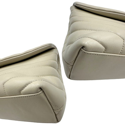 Angoli di una borsa Saint Laurent in pelle trapuntata bianco latte con tracolla scorrevole in catena e spallacci in pelle, con parti metalliche dorate e iconico logo Cassandre sul front. Completa di dustbag. Indossabile a spalla o a tracolla.