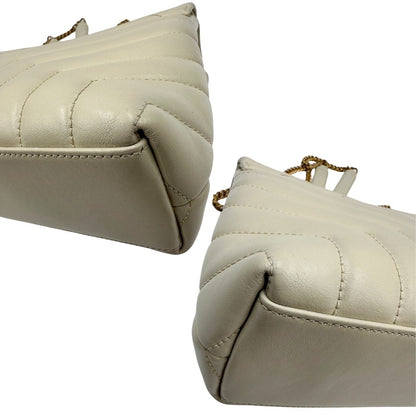 Angoli di una borsa Saint Laurent in pelle trapuntata bianco latte con tracolla scorrevole in catena e spallacci in pelle, con parti metalliche dorate e iconico logo Cassandre sul front. Completa di dustbag. Indossabile a spalla o a tracolla.