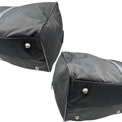 Angoli di un borsone Prada in nylon nero con finiture in pelle Saffiano tono su tono e parti metalliche argentate. Completo di dustbag, tag porta address e lucchetto. Indossabile a mano.