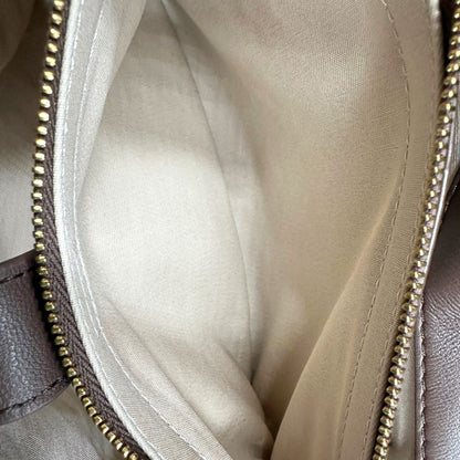 interno  Borsa Pinko in pelle matelassè marrone con parti metalliche dorate; munita di di una tracolla scorrevole con spallaccio in pelle, di lusso, originale, eccellenti condizioni, usata. 