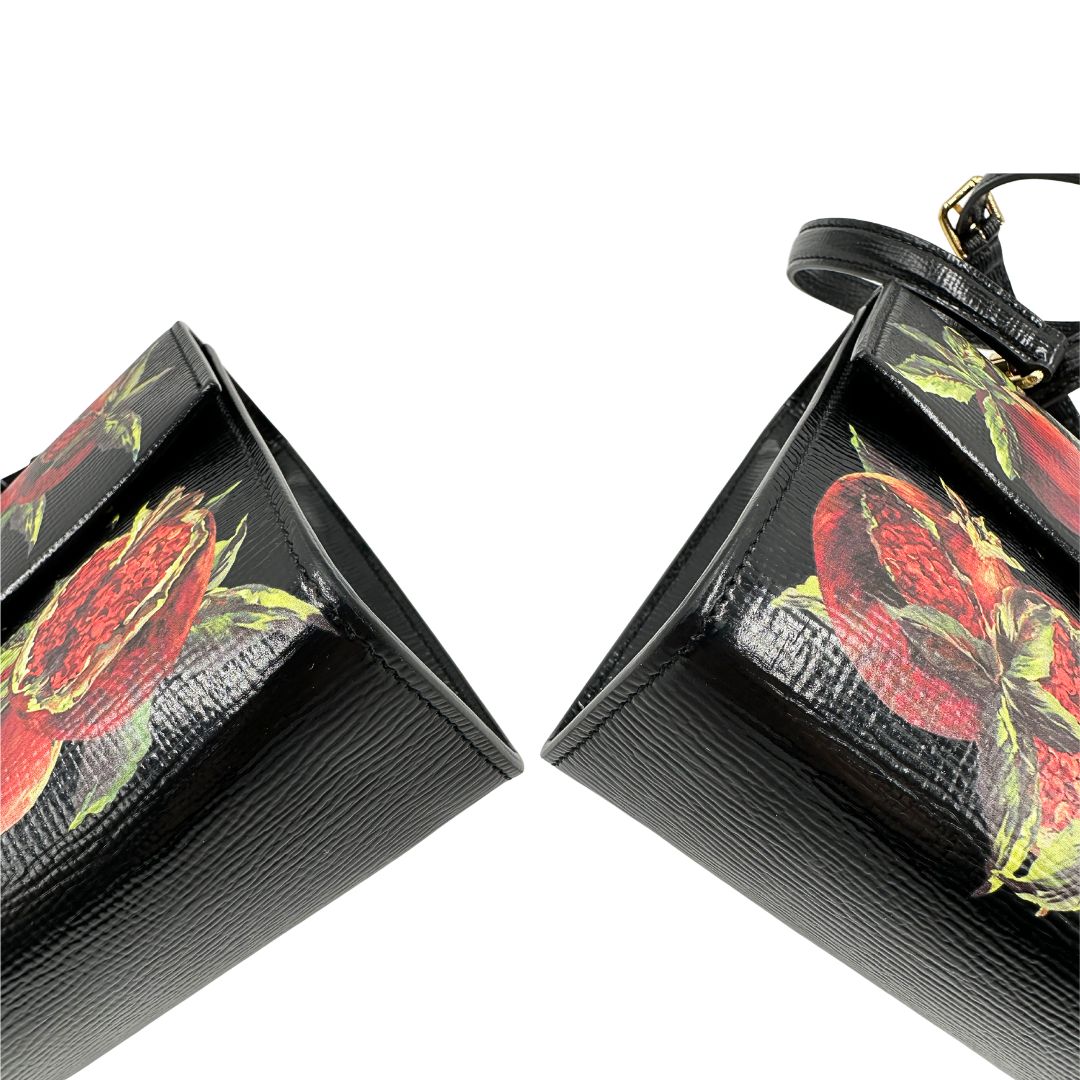 Angoli di una borsa D&G in pelle nera con stampa melograni e parti metalliche dorate; munita di un manico rigido fisso e una tracolla in pelle regolabile ed amovibile. Completa di dustbag.