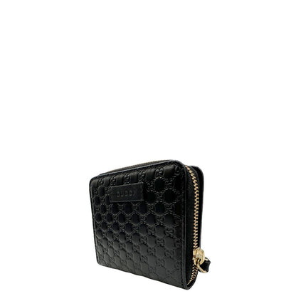 Lato sinistro, Portafoglio Gucci in pelle GG nera con hardware dorato. Originale, usato, di lusso, in ottime condizioni.