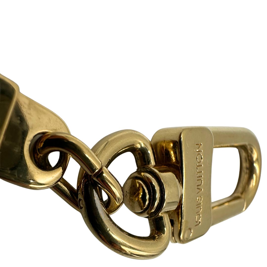 Gancio di un charm portachiavi LV in metallo dorato, corredato, usato, originale, second hand, in ottime condizioni.