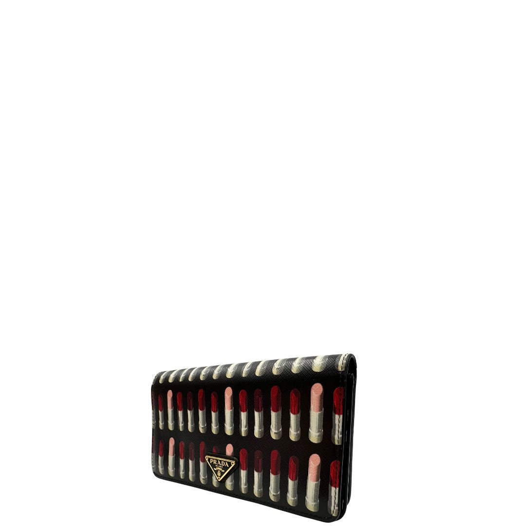 Laterale destro di un Prada WOC in pelle saffiano nera, decorato con una vivace stampa di rossetti. Indossabile a tracolla oppure a mano, usato, originale, second hand, in ottime condizioni.