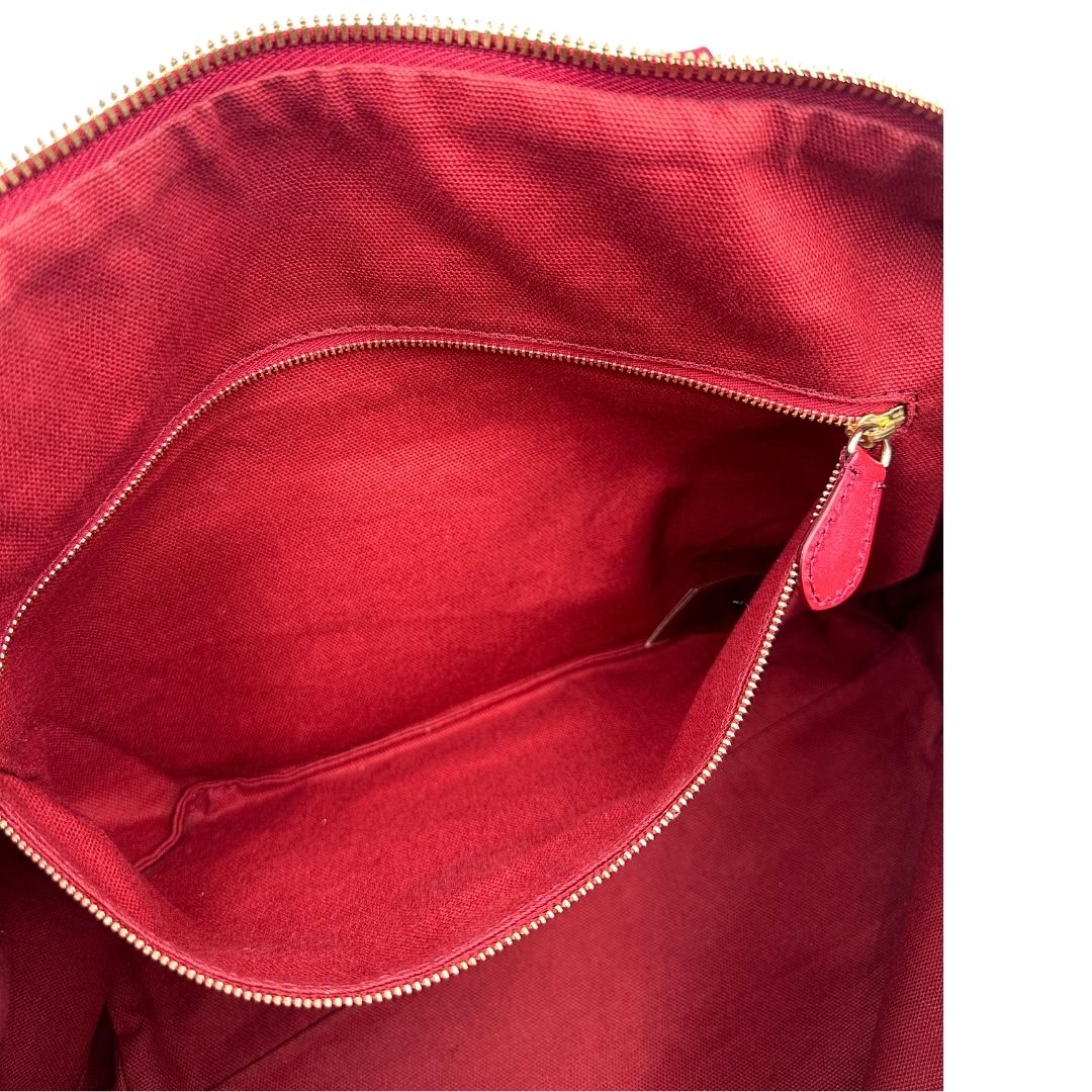 Interno di una shopper Burberry in canvas trama tartan con finiture in pelle bordeaux, usata, originale, second hand, in ottime condizioni.