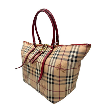 Laterale destro di una shopper Burberry in canvas trama tartan con finiture in pelle bordeaux, usata, originale, second hand, in ottime condizioni.