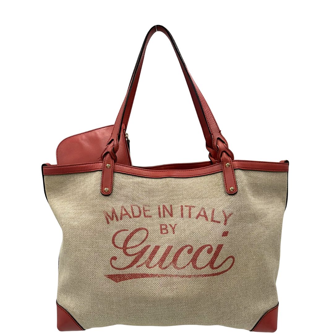 Front di una shopper Gucci Craft in tela beige, con finiture in pelle color rosa corallo. Dotata anche di una comoda pochette estraibile, usata, originale, second hand, in ottime condizioni.