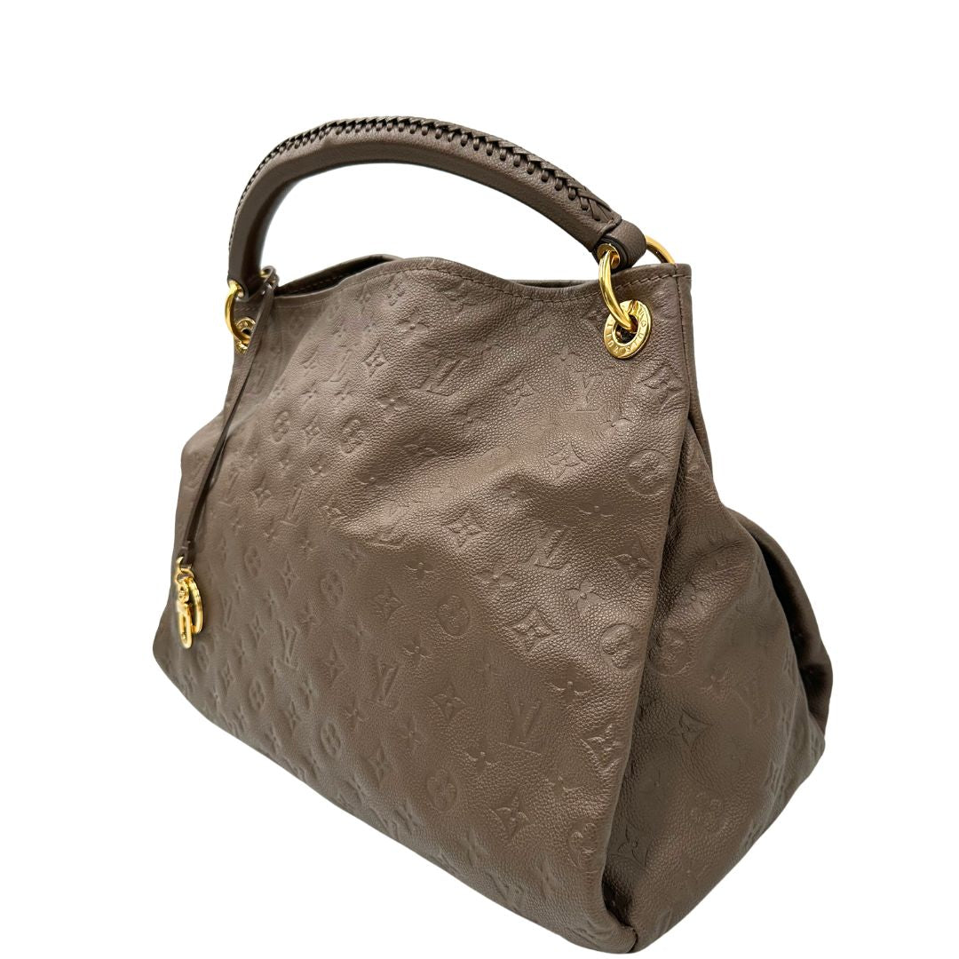 Laterale destro di una borsa Artsy Louis Vuitton nella versione MM in una calda tonalità color nocciola, corredata, usata, originale, second hand, in ottime condizioni.