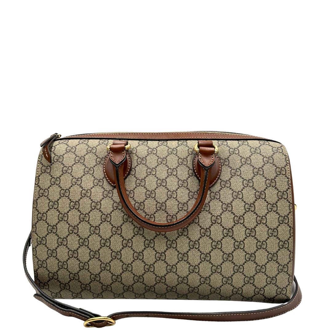 Retro di un bauletto Gucci GG in canvas beige, con parti in pelle marroni, usato, originale, second hand, in ottime condizioni.