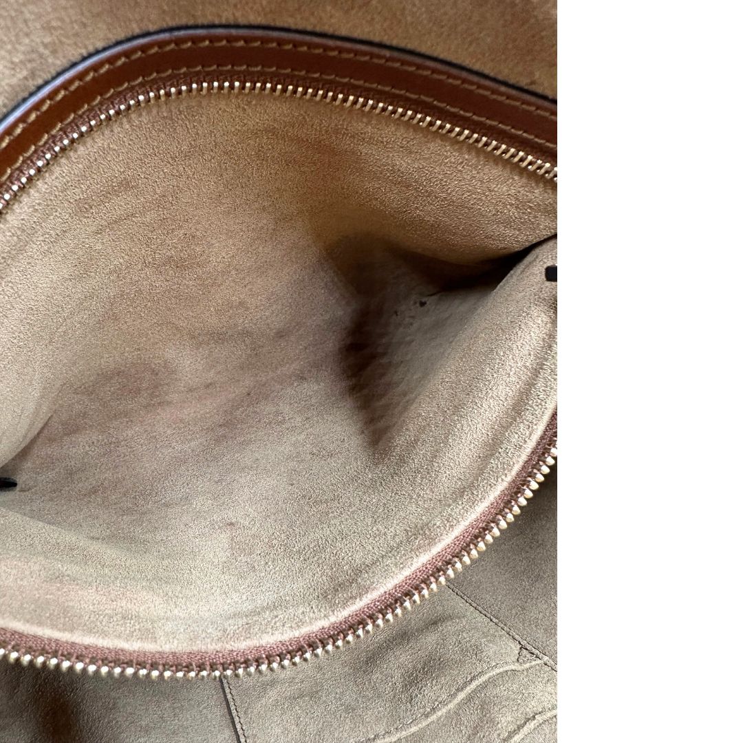 Interno di un bauletto Gucci GG in canvas beige, con parti in pelle marroni, usato, originale, second hand, in ottime condizioni.