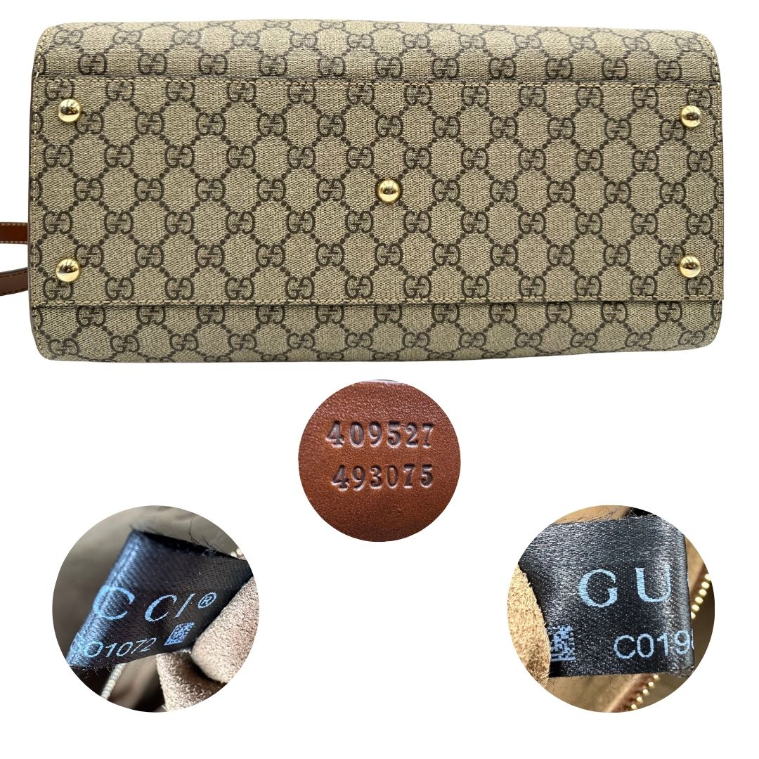 Base e codici di un bauletto Gucci GG in canvas beige, con parti in pelle marroni, usato, originale, second hand, in ottime condizioni.