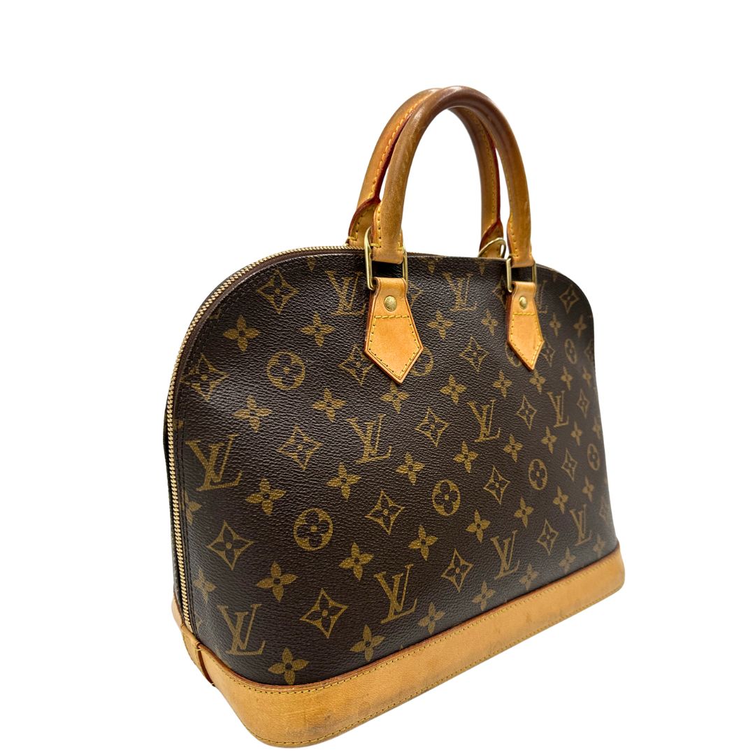 Laterale sinistro di una Louis Vuitton Alma in tela monogram nella versione PM, usata, originale, second hand, in ottime condizioni.