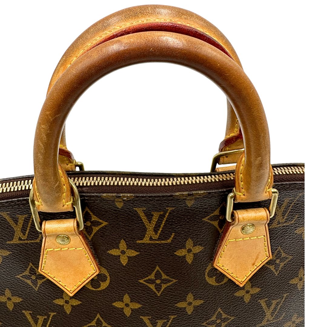 Manici di una Louis Vuitton Alma in tela monogram nella versione PM, usata, originale, second hand, in ottime condizioni.