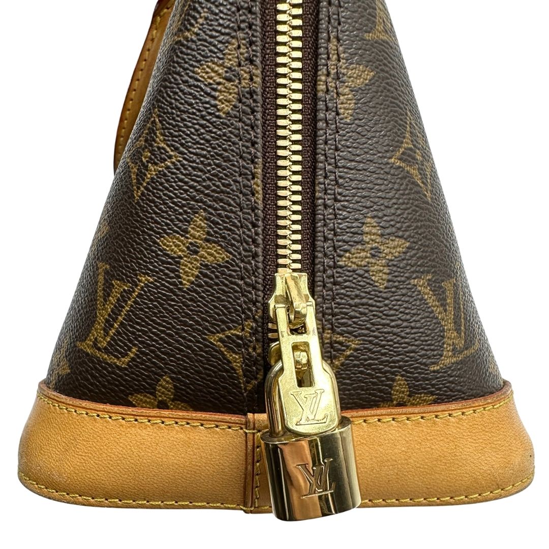 Laterale destro di una Louis Vuitton Alma in tela monogram nella versione PM, usata, originale, second hand, in ottime condizioni.