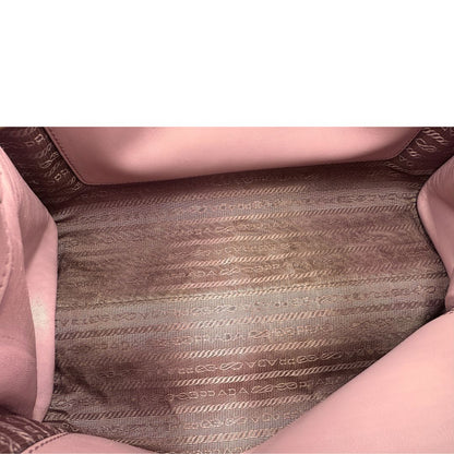 Interno di una borsa Prada rosa in pelle saffiano, dotata di un pratico charm con specchietto amovibile, usata, originale, second hand, in ottime condizioni.