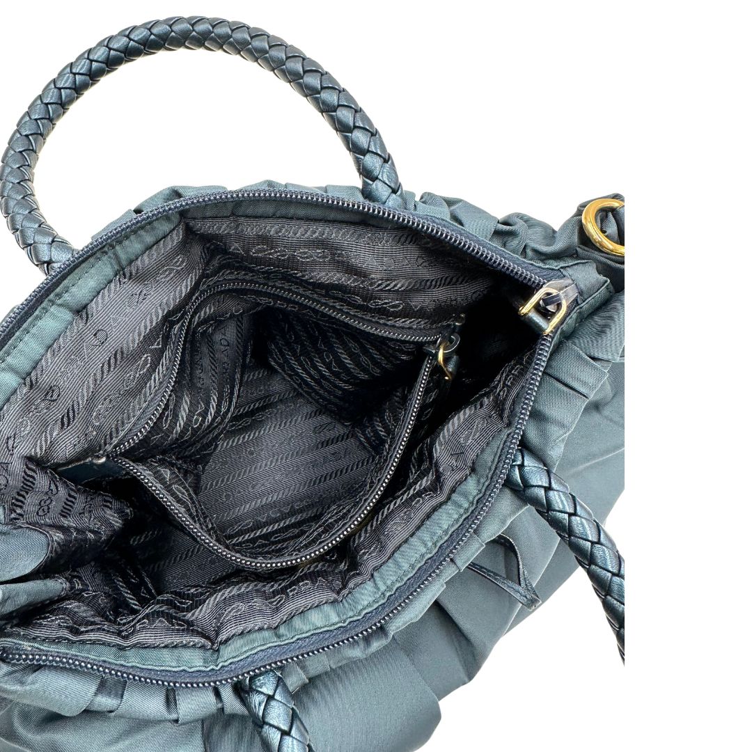 interno Borsa Prada in nylon nelle tonalità del blu petrolio, munita di doppi manici in pelle intrecciati, di lusso, originale, ottime condizioni, usata. 