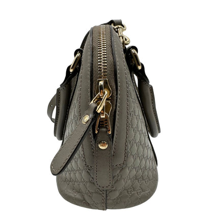 lato Borsa Gucci in pelle microgucissima grigia, di lusso, originale, ottime condizioni, usata.
