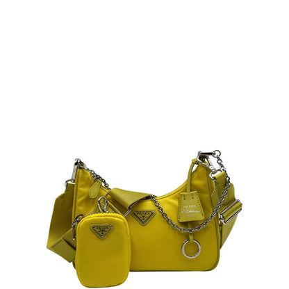 Front di una borsa a tracolla Prada in re-nylon giallo con pouch amovibile.