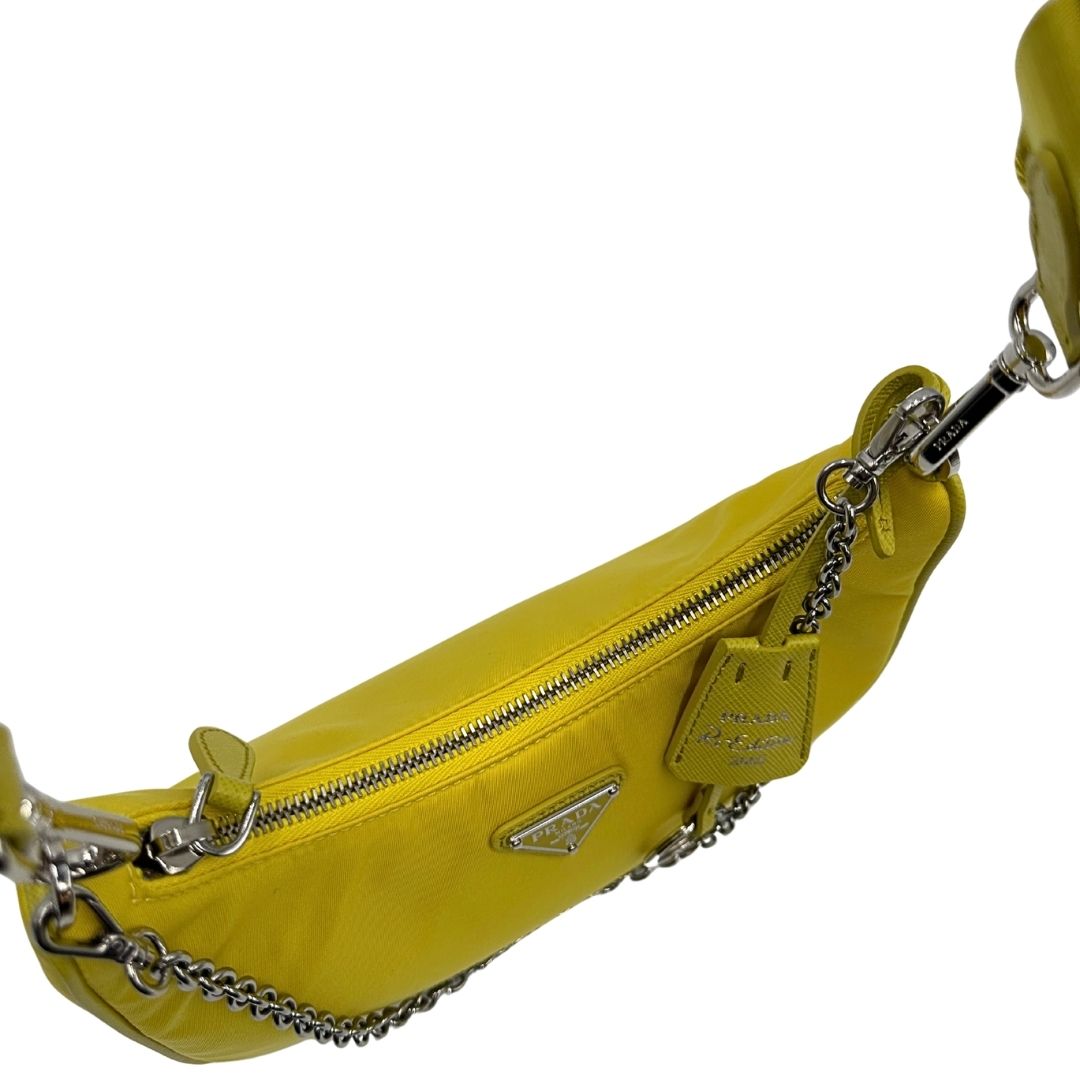 Vista superiore di una borsa a tracolla Prada in re-nylon giallo con pouch amovibile, usata, originale, second hand, in condizioni eccellenti.