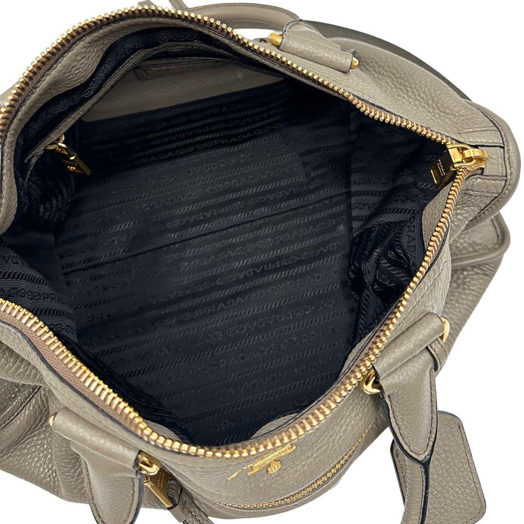 Interno, Pratica borsa Prada in pelle martellata grigia e hardware dorato, Indossabile a mano oppure a tracolla. Originale, usata, di lusso, in ottime condizioni.