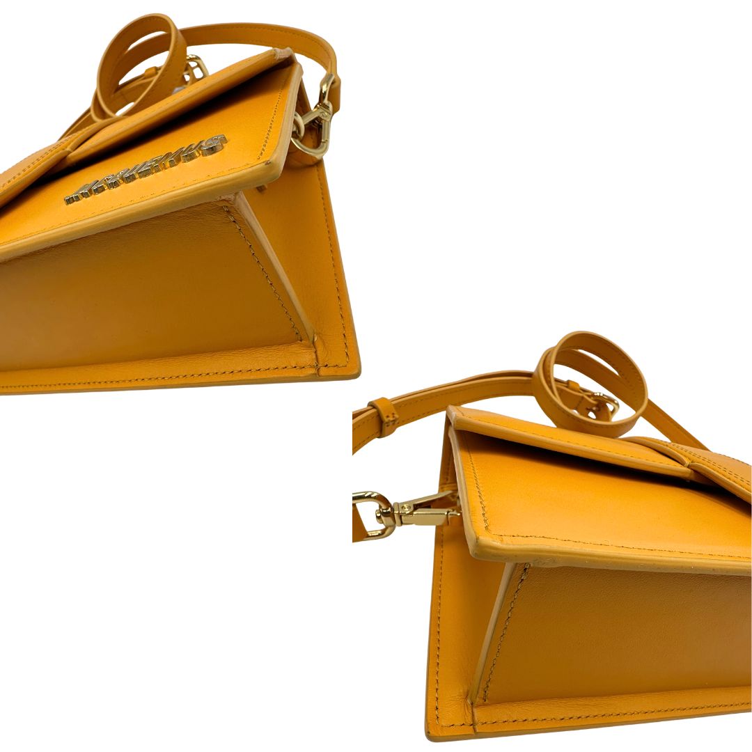 angoli  Borsa Jacquemus nella versione Le Grand Bambino in pelle color zafferano, di lusso, originale, ottime condizioni, usata. 
