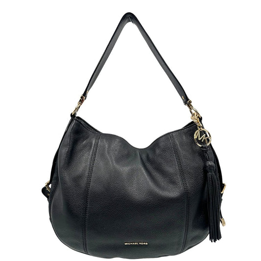 front borsa Michael Kors in pelle nera e hardware dorato, impreziosita da nappa decorativa amovibile, indossabile a spalla, di lusso, originale, ottime condizioni, usata. 