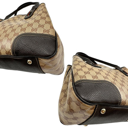 angoli Borsa Gucci in tela cerata GG con finiture in pelle marroni, munita di doppi manici in pelle, impreziosita da dettagli Web verdi e rossi, di lusso, originale, ottime condizioni, usata. 