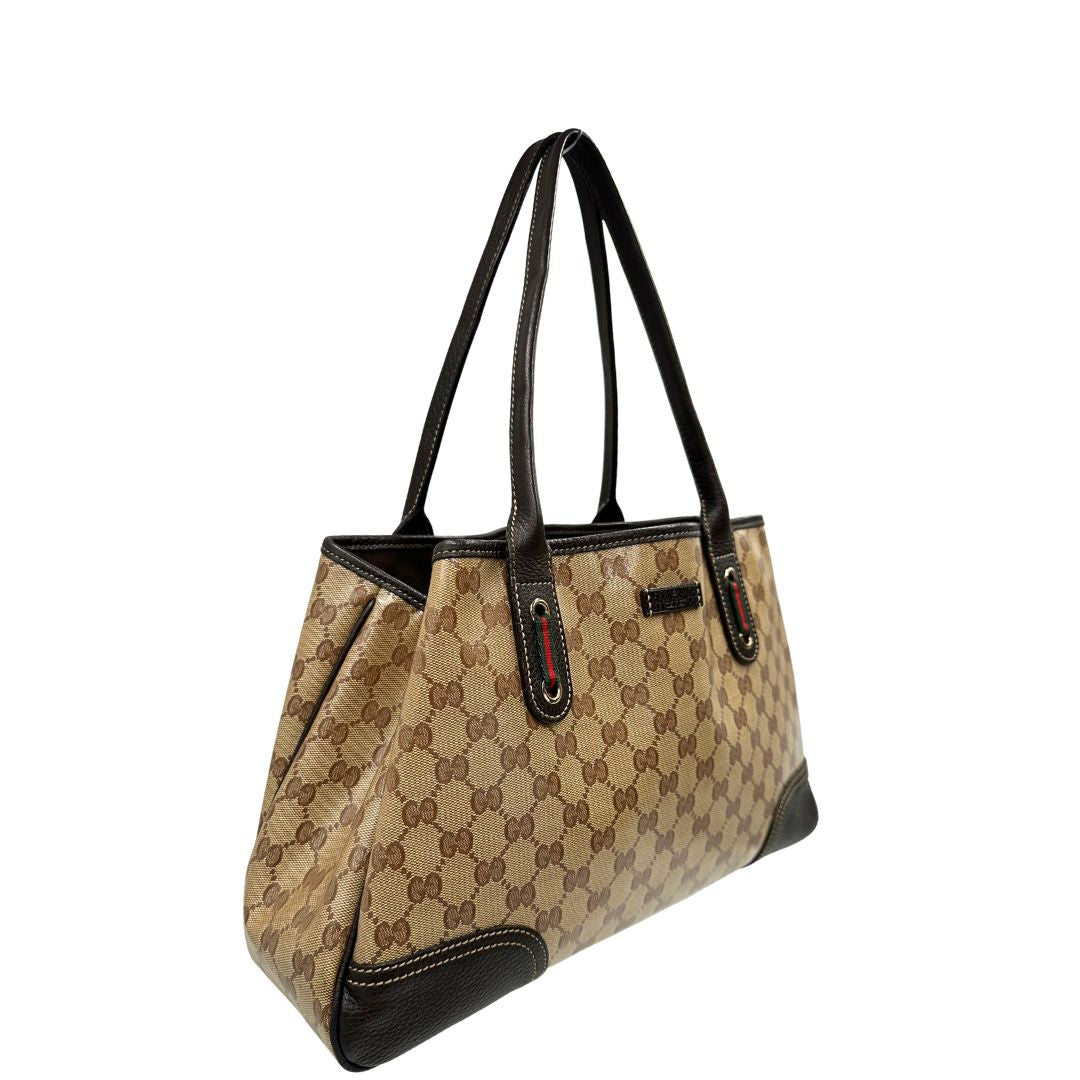 lato Borsa Gucci in tela cerata GG con finiture in pelle marroni, munita di doppi manici in pelle, impreziosita da dettagli Web verdi e rossi, di lusso, originale, ottime condizioni, usata. 