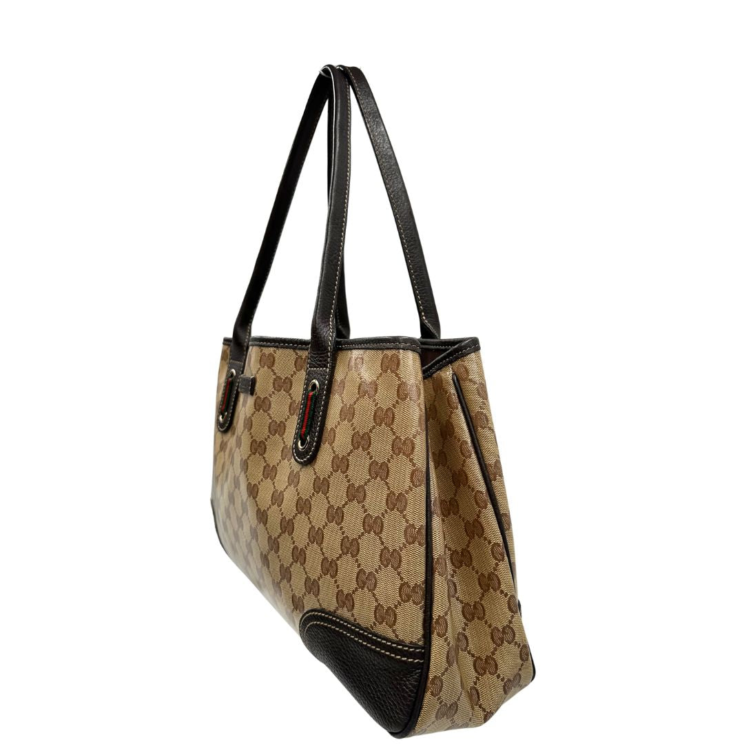 lato Borsa Gucci in tela cerata GG con finiture in pelle marroni, munita di doppi manici in pelle, impreziosita da dettagli Web verdi e rossi, di lusso, originale, ottime condizioni, usata. 