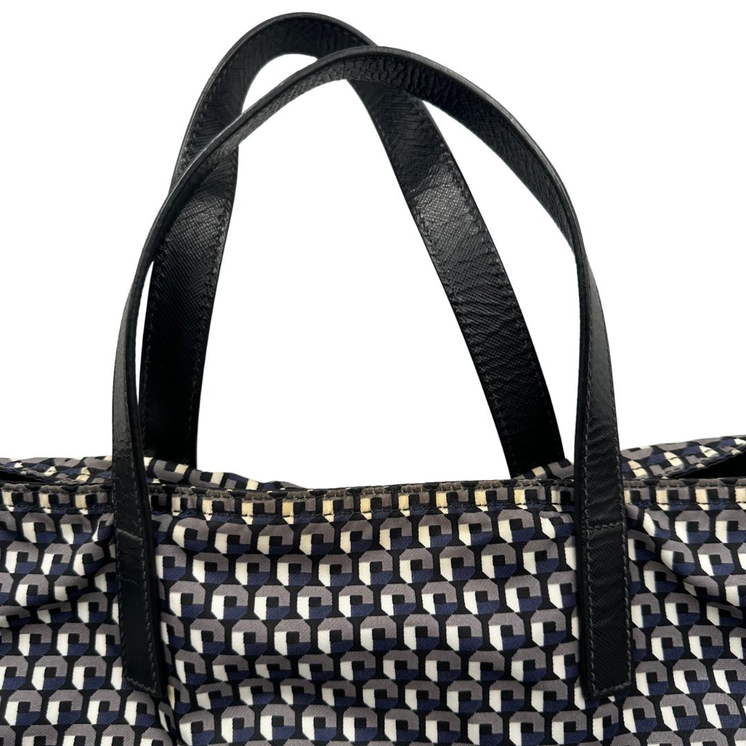 manici Borsa Prada in nylon stampato con motivo geometrico all-over nei toni del blu e bianco, arricchita da doppi manici in pelle nera, di lusso, originale, ottime condizioni, usata. 