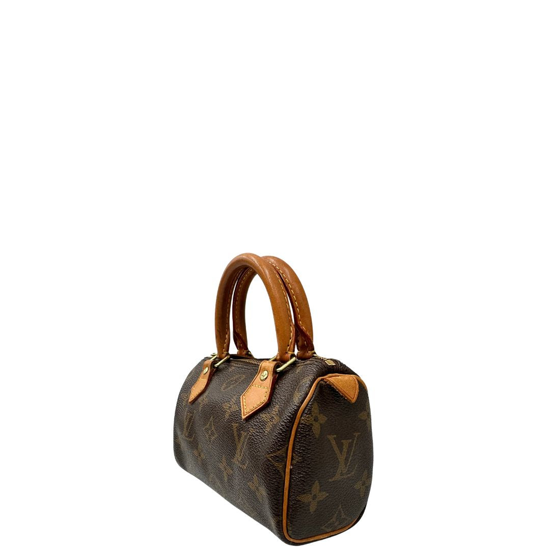 Laterale destro di uno Speedy Nano Louis Vuitton in canvas marrone monogram, usato, originale, second hand, in ottime condizioni.