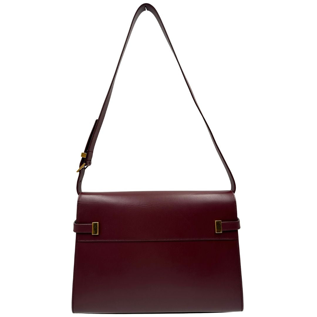 Borsa Saint Laurent Manhattan in pelle bordeaux e hardware dorato, da portare a spalla.
