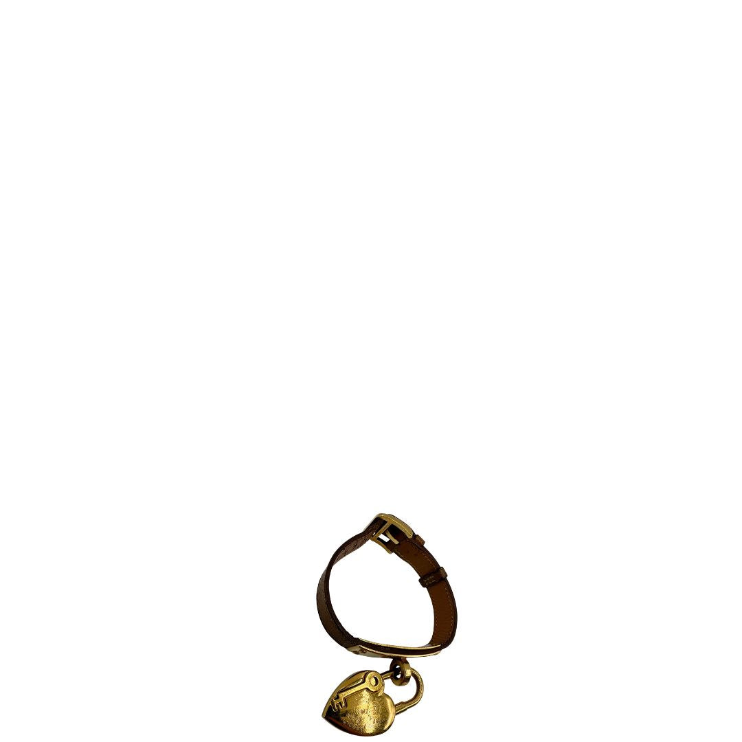 Elegante Hermès Année de la Fantaisie "Vive l'Idée!", bracciale in pelle marrone con finiture dorate e un caratteristico lucchetto a forma di cuore.