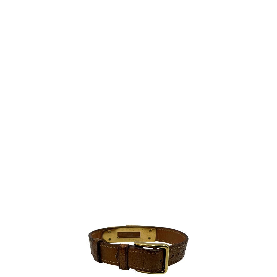 Elegante Hermès Année de la Fantaisie "Vive l'Idée!", bracciale in pelle marrone con finiture dorate e un caratteristico lucchetto a forma di cuore.