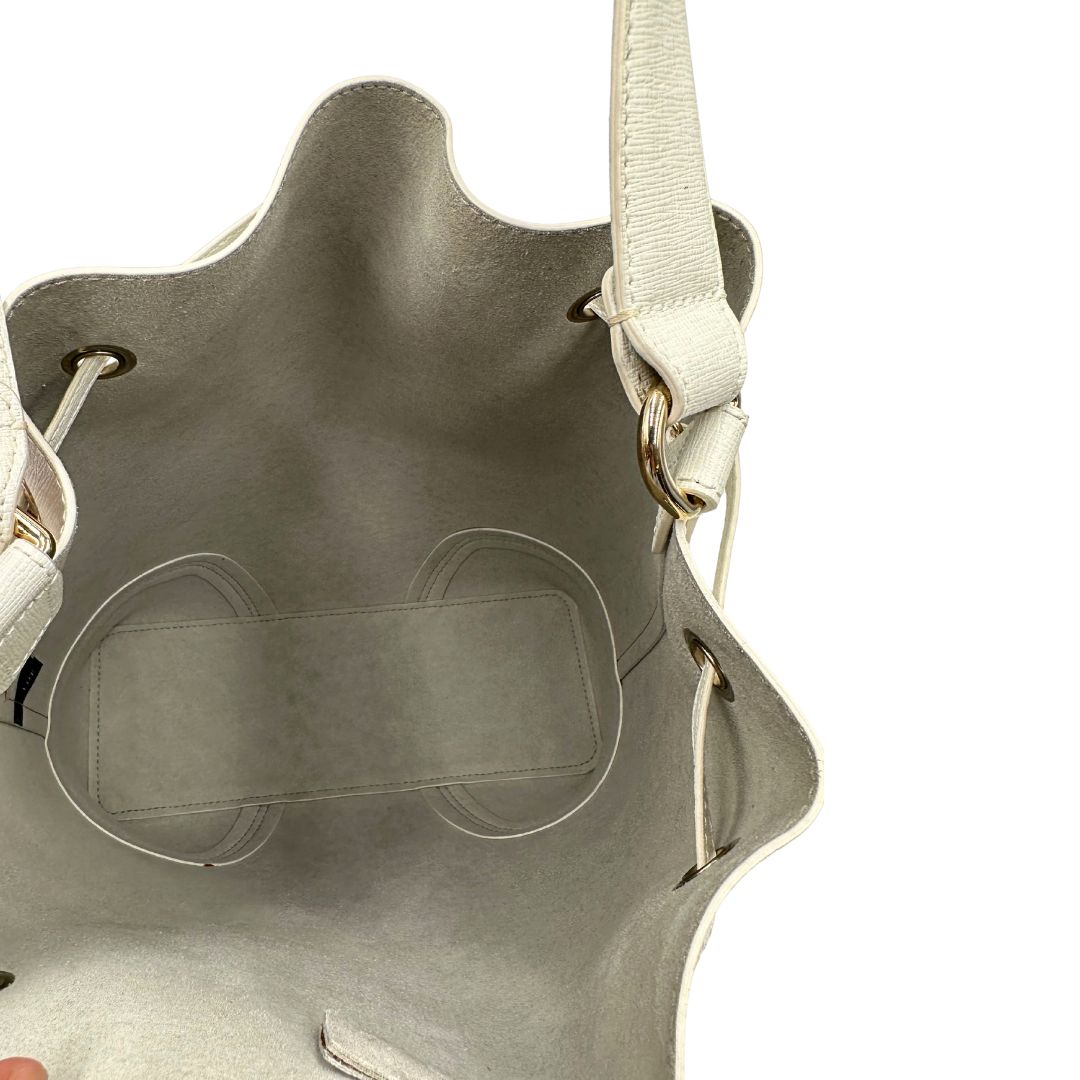 Interno di un bucket Furla in pelle bianco gesso con parti metalliche dorate; munito di un manico singolo e pochette estraibile ed amovibile. Completo di dustbag.