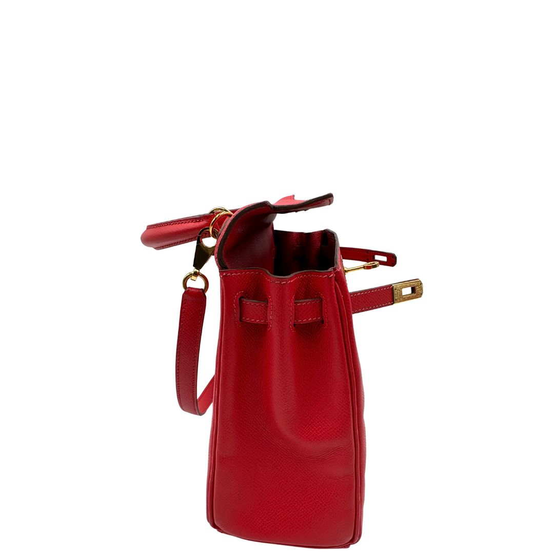 Vista laterale di una borsa Hermès caratterizzata da un corpo in pelle Epsom color Rouge Casaque, un manico superiore e una tracolla piatta rimovibile e non regolabile; da portare a mano o a tracolla. Completa di full set.