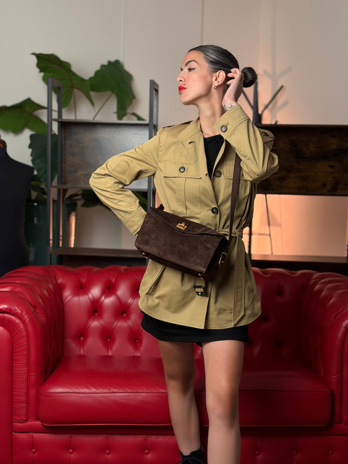 Donna in trench con una borsa a tracolla