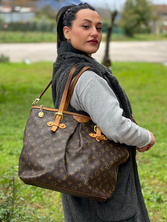 Ragazza che indossa una Borsa Palermo GM Louis Vuitton in canvas marrone monogram con finiture in vacchetta naturale e parti metalliche dorate. Originale, usato, di lusso, in ottime condizioni.