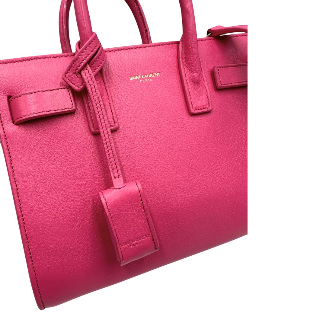 Sac De Jour nano Saint Laurent in pelle rosa babrie con doppi manici stondati e tracolla regolabile, e amovibile. Parti metalliche dorate. Originale, usato, condizioni ottime. 