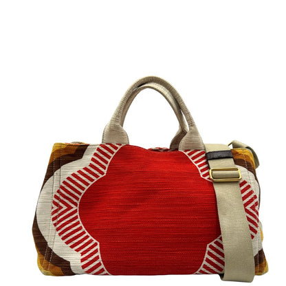 Borsa Prada in tessuto trama multicolore, con inserti metallici dorati; dotata di doppi manici e una tracolla amovibile e regolabile. Indossabile a mano o a tracolla. Completa di card d'autenticità.