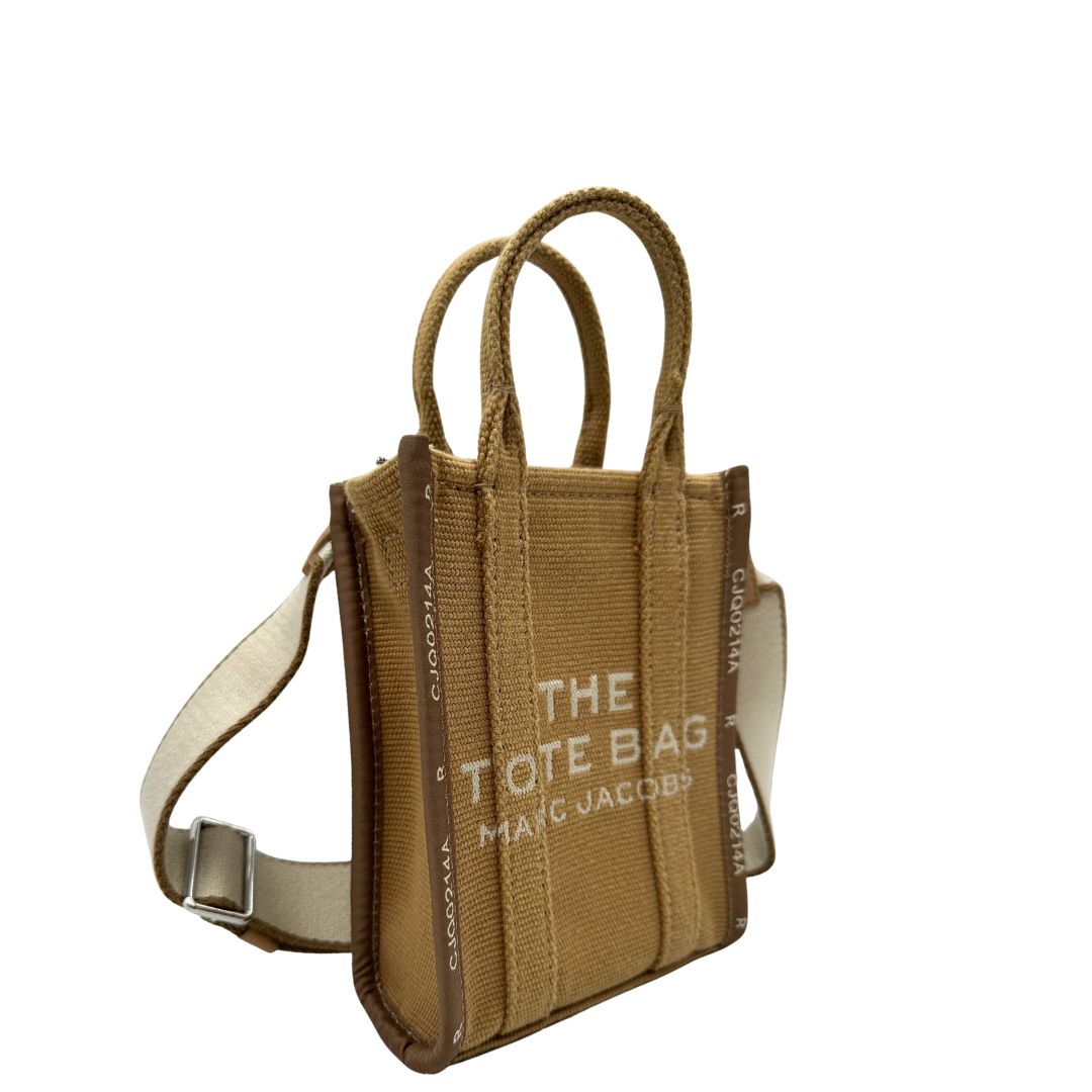 Laterali The Tote Bag Marc Jacobs in tessuto Jacquard con tracolla regolabile e amovibile in tessuto Bianco, rifinita con parti metalliche argentate.