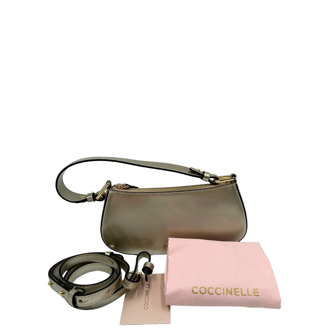 Borsa Coccinelle in pelle color champagne munita di un manico singolo, una tracolla regolabile e amovibile con parti metalliche dorate. 