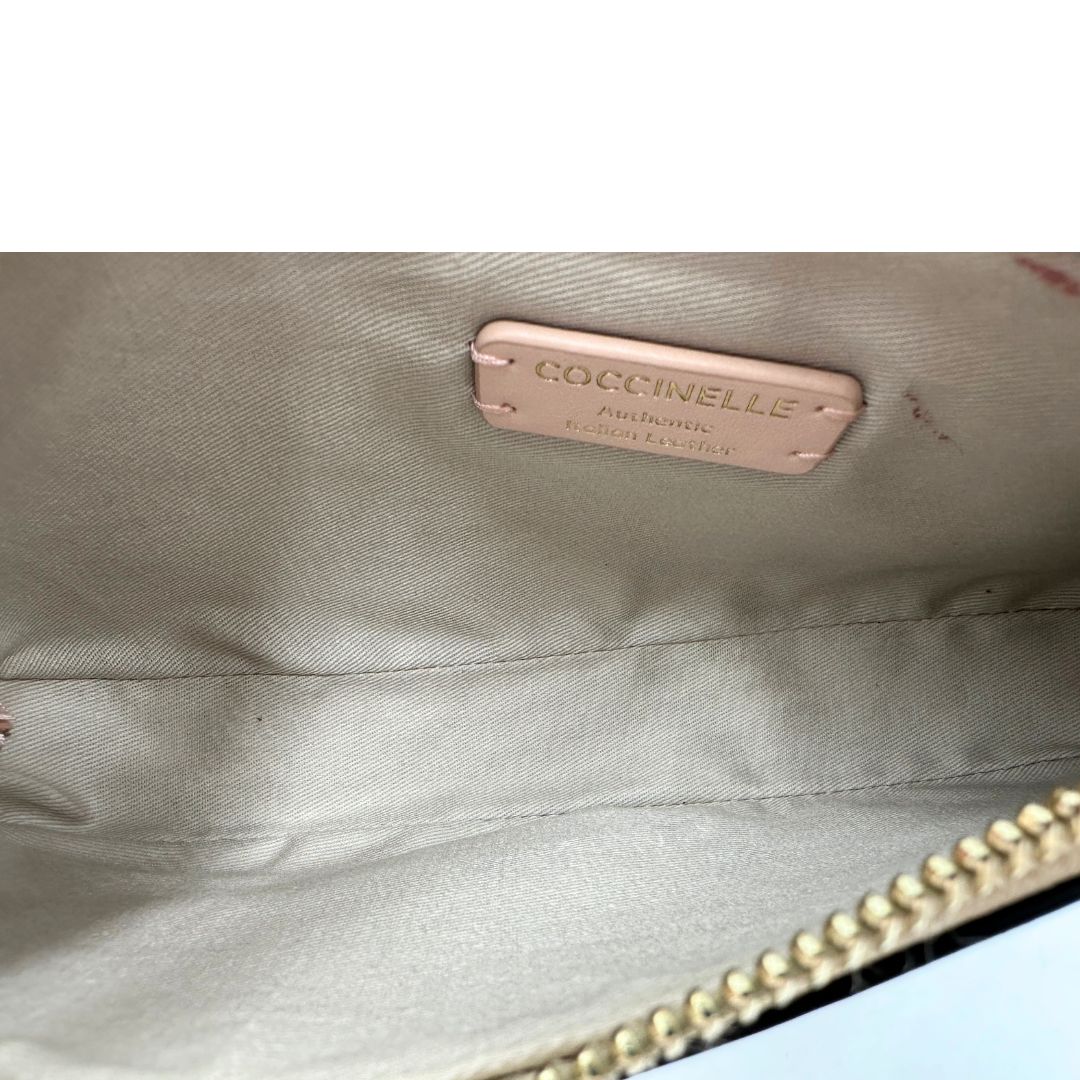 Interno Borsa Coccinelle in pelle color champagne munita di un manico singolo, una tracolla regolabile e amovibile con parti metalliche dorate. 