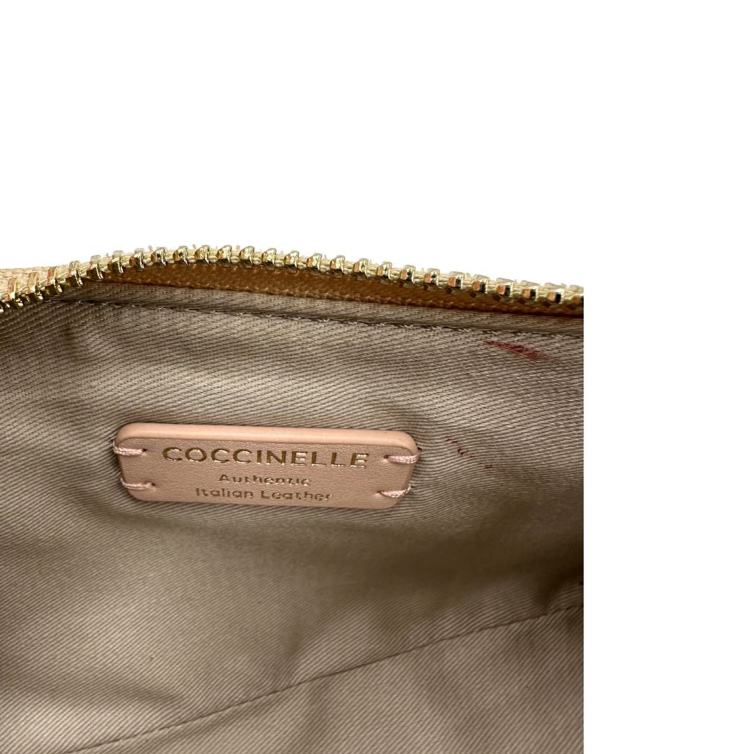 Interno Borsa Coccinelle in pelle color champagne munita di un manico singolo, una tracolla regolabile e amovibile con parti metalliche dorate. 