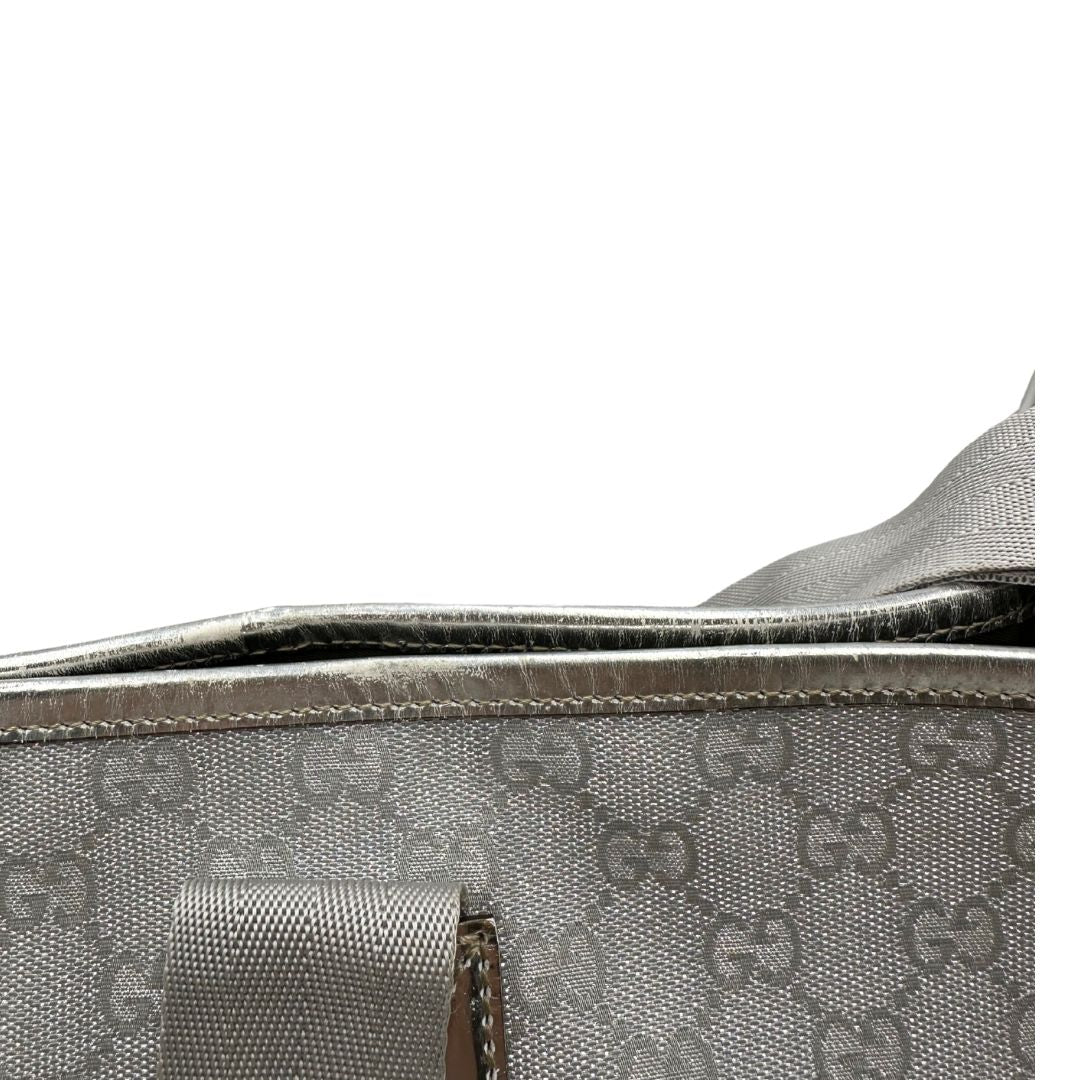 Borsa Gucci in canvas grigio laminato GG con finiture in pelle Tono su tono e parti metalliche argentate. Dotata di Doppi manici e tracolla in tessuto regolabile.