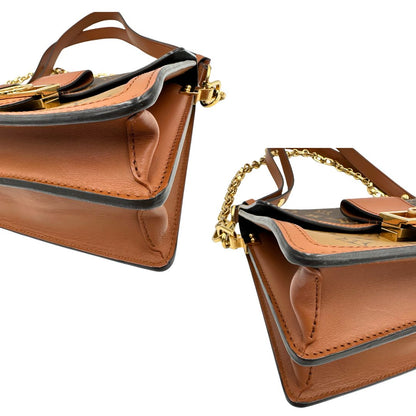  angoli Borsa Dauphine MM Louis Vuitton in tela monogram, e monogram reverse bicolore con finiture in pelle cognac e parti metalliche dorate. Munita di una tracolla in pelle e un manico in catena, amovibili. Originale, usato, di lusso, in ottime condizioni 