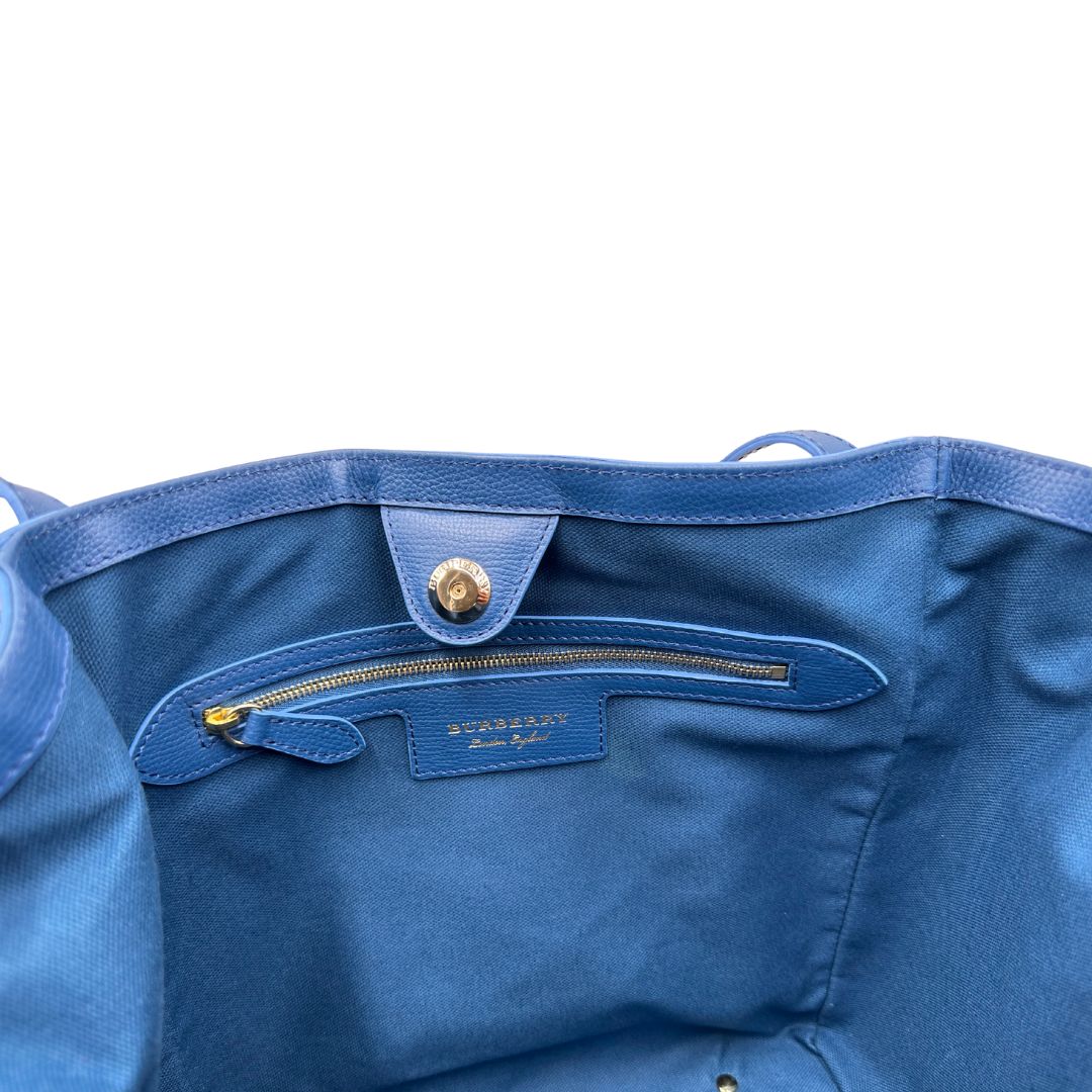 Tasca di una Borsa Burberry in canvas beige trama tartan rifinita con parti in pelle blu e impreziosita da stampa floreale; indossabile a spalla. Originale, usata, di lusso, in ottime condizioni.