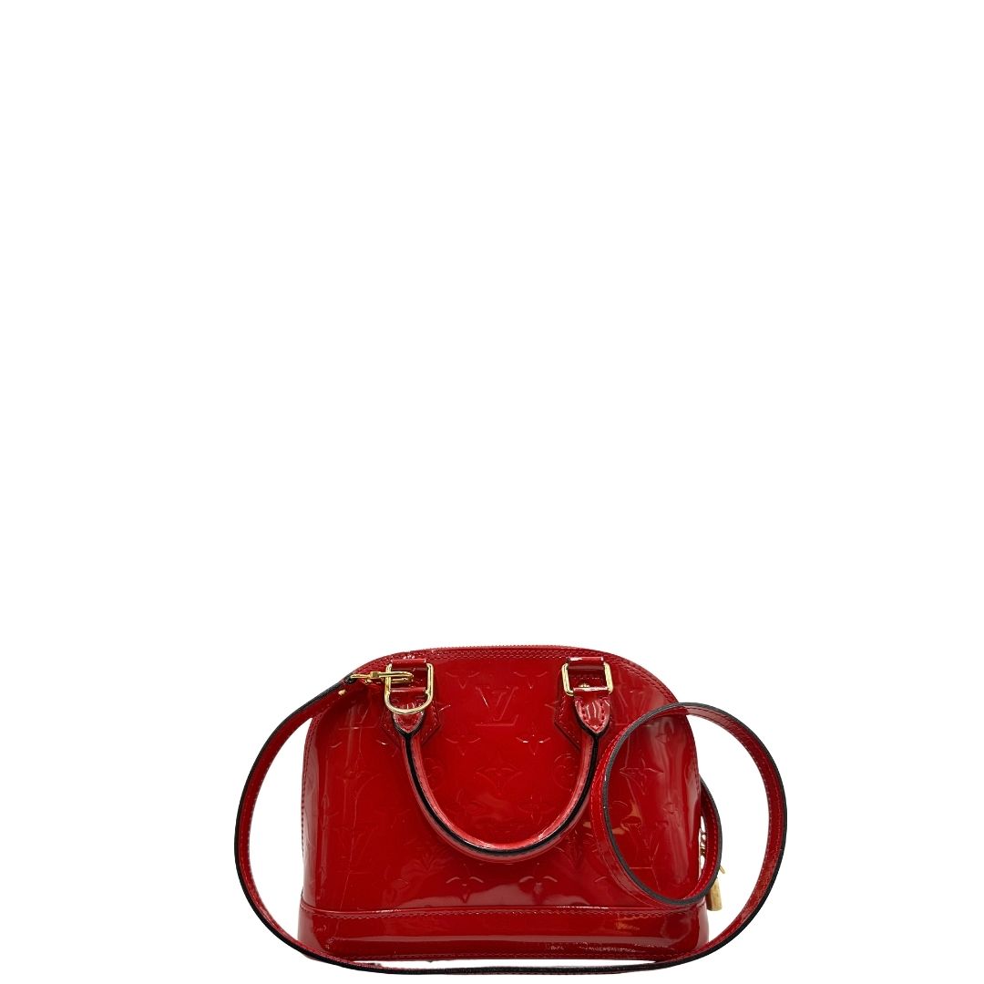 retro  Borsa Louis Vuitton Alma BB in pelle vernis rossa con trama monogram empreinte e parti metalliche dorate. Munita di doppi manici stondati e tracolla amovibile, dotata di clochette porta chiavi. Completa di scatola, lucchetto e chiavi, di lusso, originale, ottime condizioni.