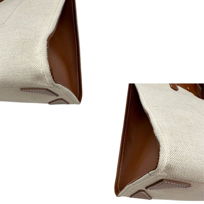 angoli Borsa Balmain in tessuto color sabbia rifinita con parti in pelle marroni; munita di doppi manici e una pochette estraibile 